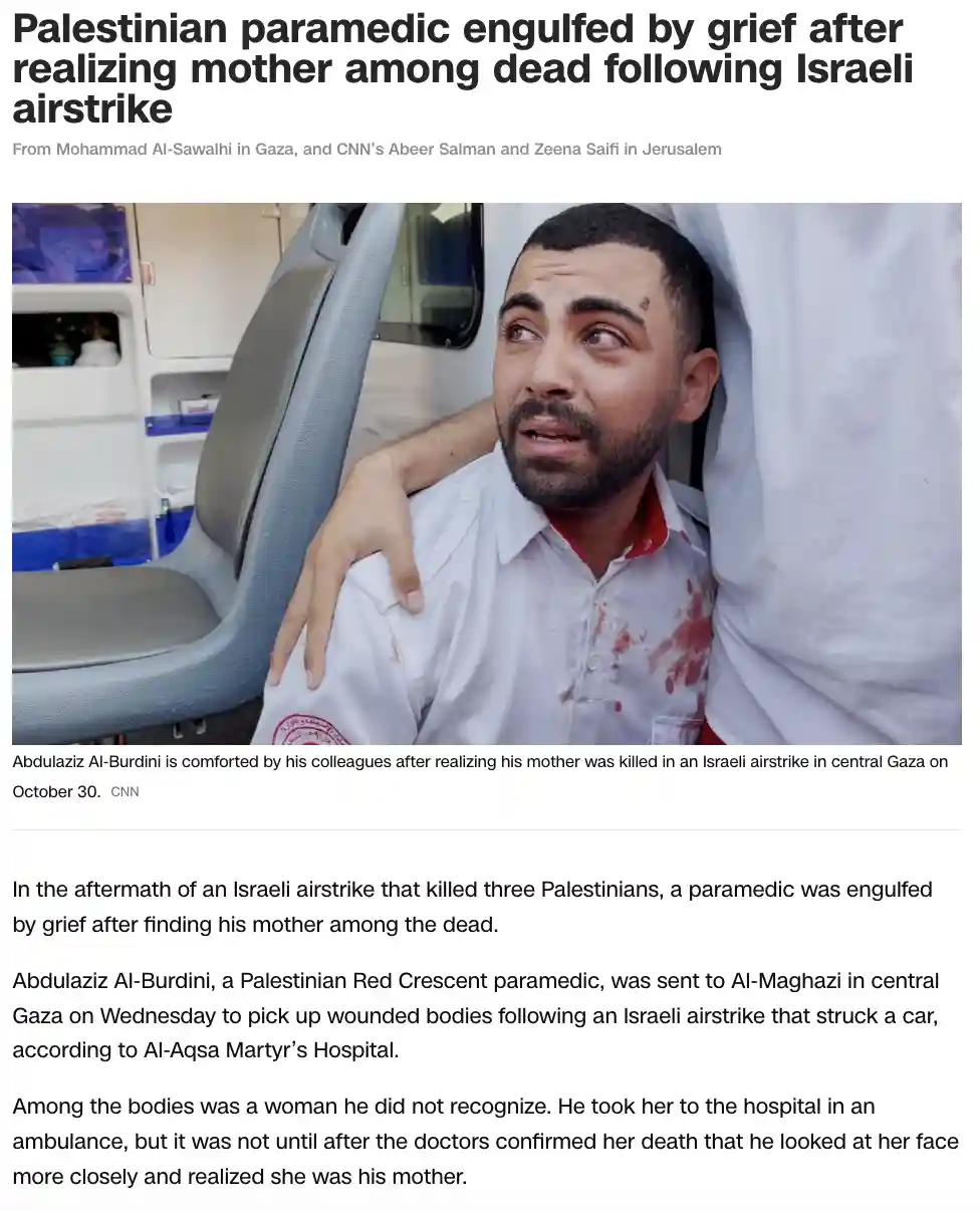A Palestinian paramedic in a blood-stained white uniform sits in an ambulance, visibly distraught with tears in his eyes and…