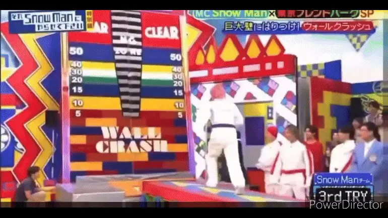 A split-screen sequence from a Japanese game show shows a contestant in a white outfit attempting a wall-climbing challenge…