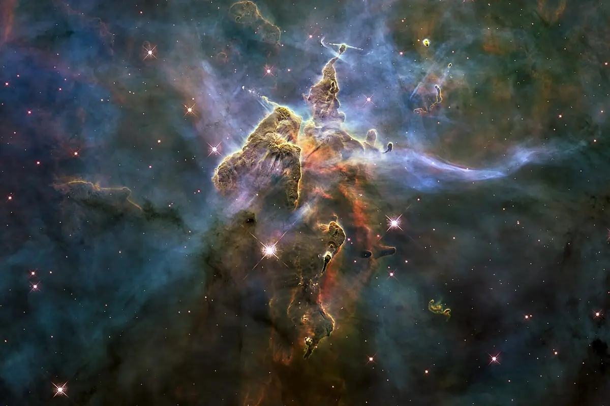 this is a stunning space photograph of the pillars of creation within the eagle nebula, showing towering columns of gas and…
