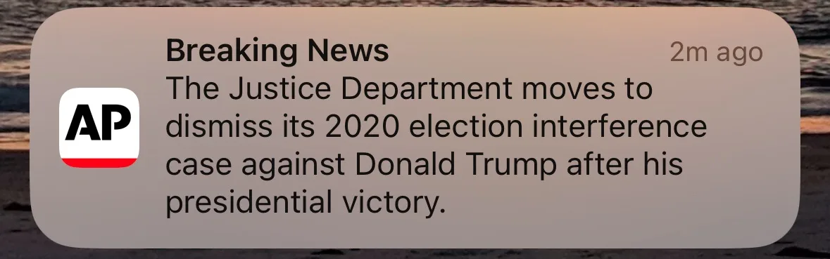 A screenshot of a news notification from the Associated Press (AP) with a brownish background and rounded corners. The text…