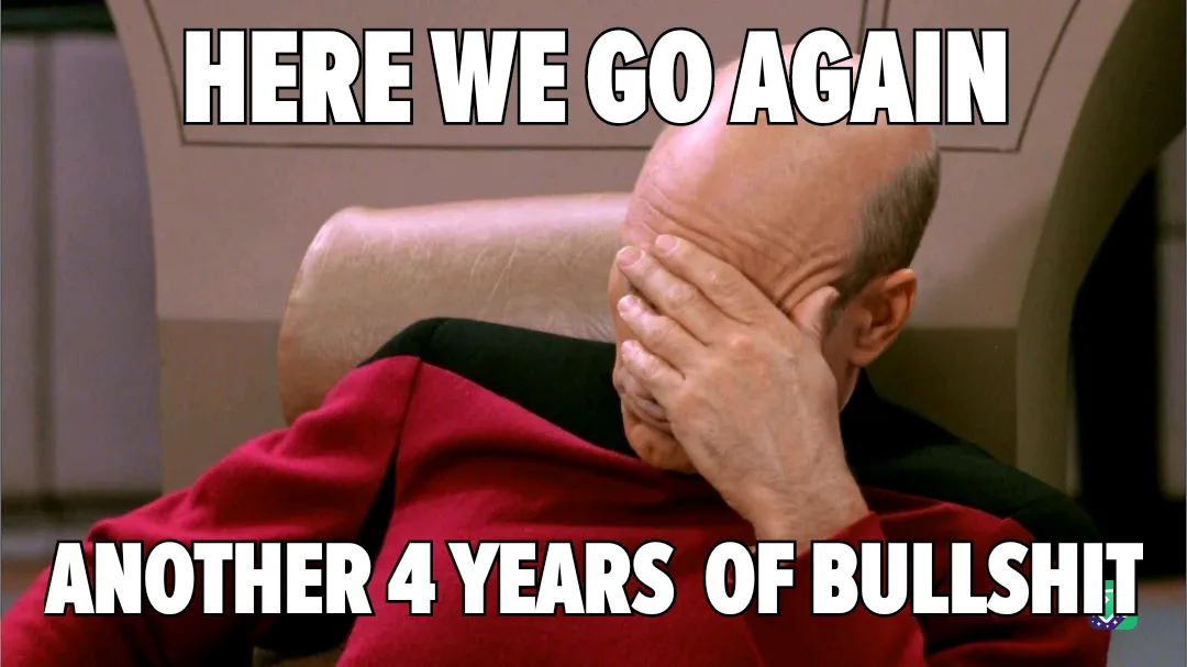 A bald man in a red uniform sits in a chair, covering his face with his hand in a gesture of despair or resignation. The…