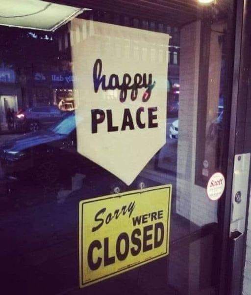 A glass door shows two signs: a white banner reads 'happy PLACE' with a small red chili pepper graphic above the word…