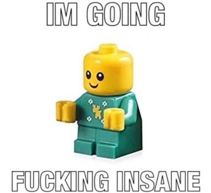 A yellow-headed Lego minifigure wearing a green sweater with white snowflake and yellow star patterns stands against a plain…