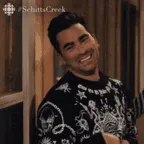 A man in a black and white patterned sweater smiles and says 'take care!' while looking at someone off-screen, then his…