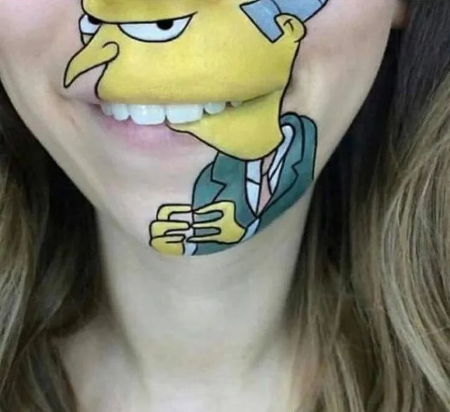 A close-up of a person's face and neck with a detailed face paint or temporary tattoo of Homer Simpson from The Simpsons…