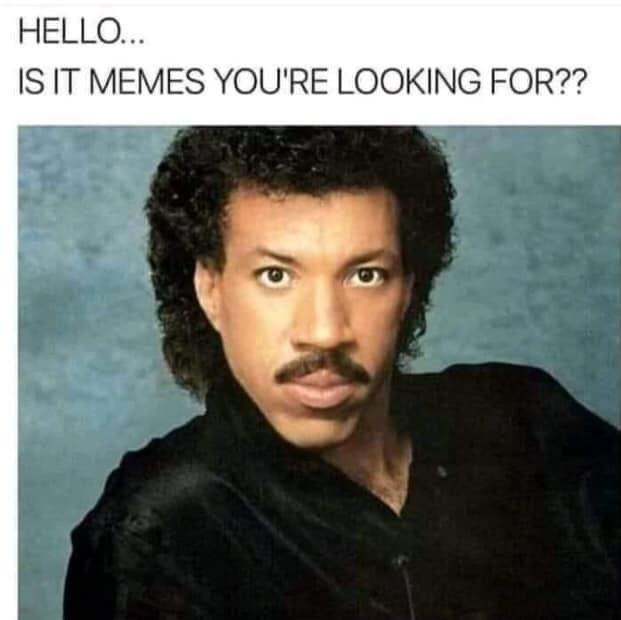 A vintage photo of a man with curly hair and a mustache, wearing a black shirt, staring intently at the camera against a…