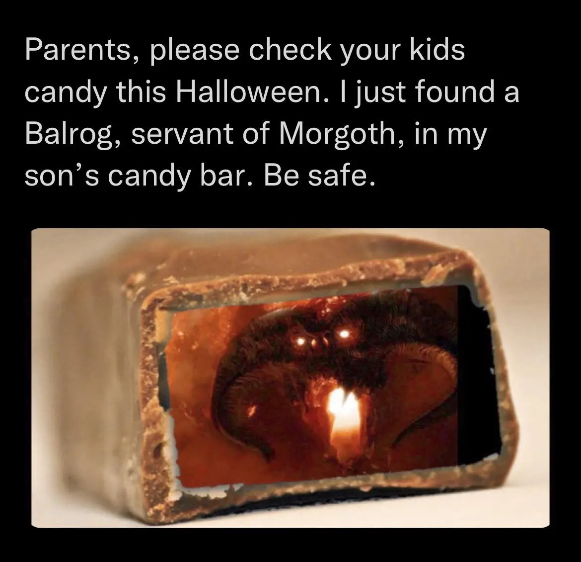 A close-up photo shows a broken open chocolate candy bar with a dark, fiery, demonic face with glowing eyes and a torch-like…