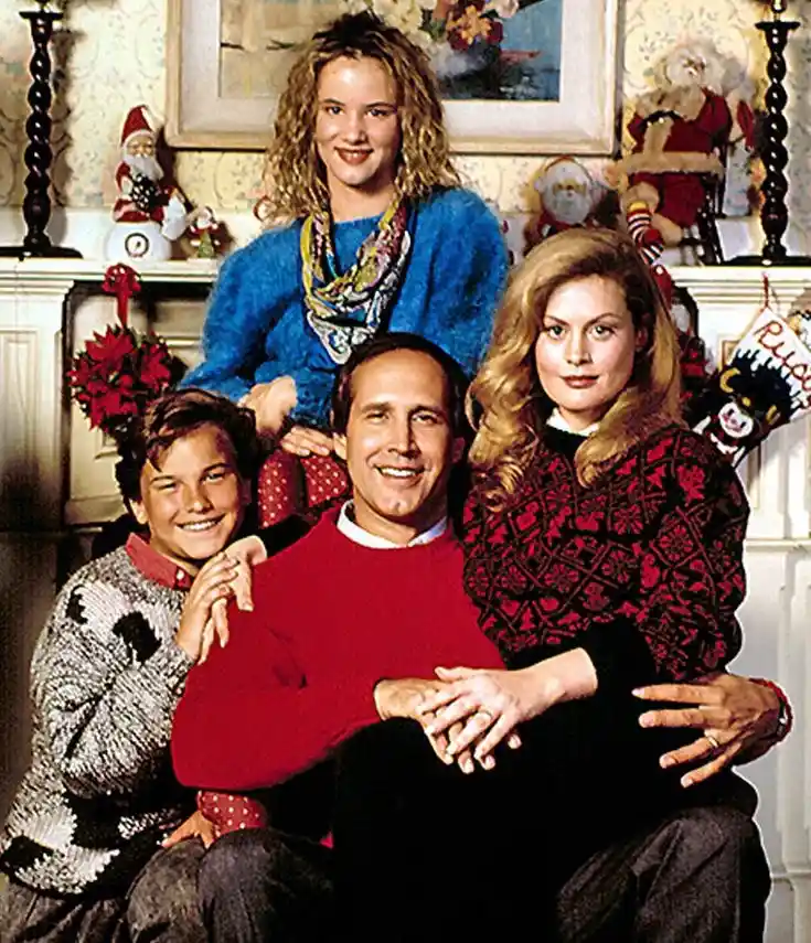 a family photo from the 1990s Christmas movie 'The Grinch' featuring the Grinch's family: a man in a red sweater, a woman in…