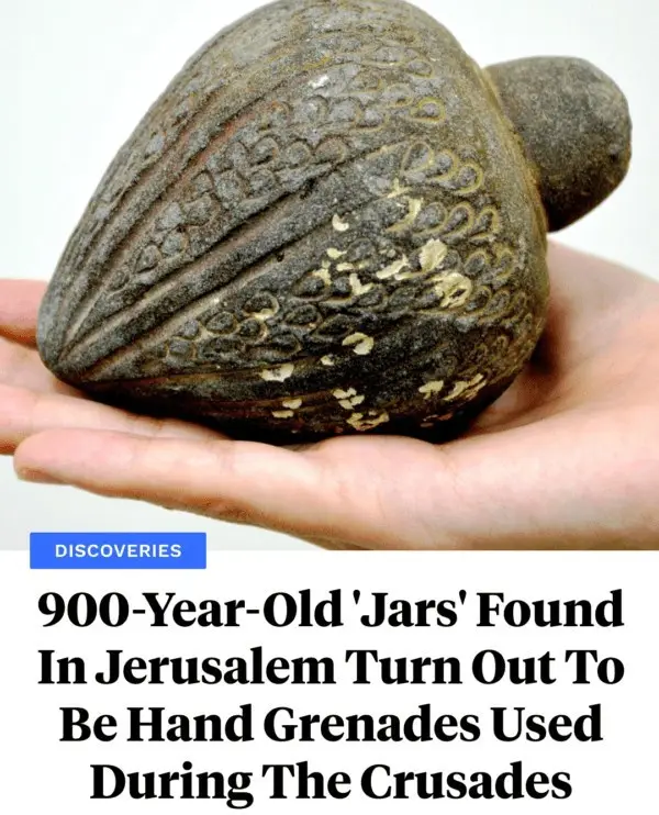 A hand holds a dark, ornately carved stone object resembling a jar or grenade with intricate patterns. Below, a news…