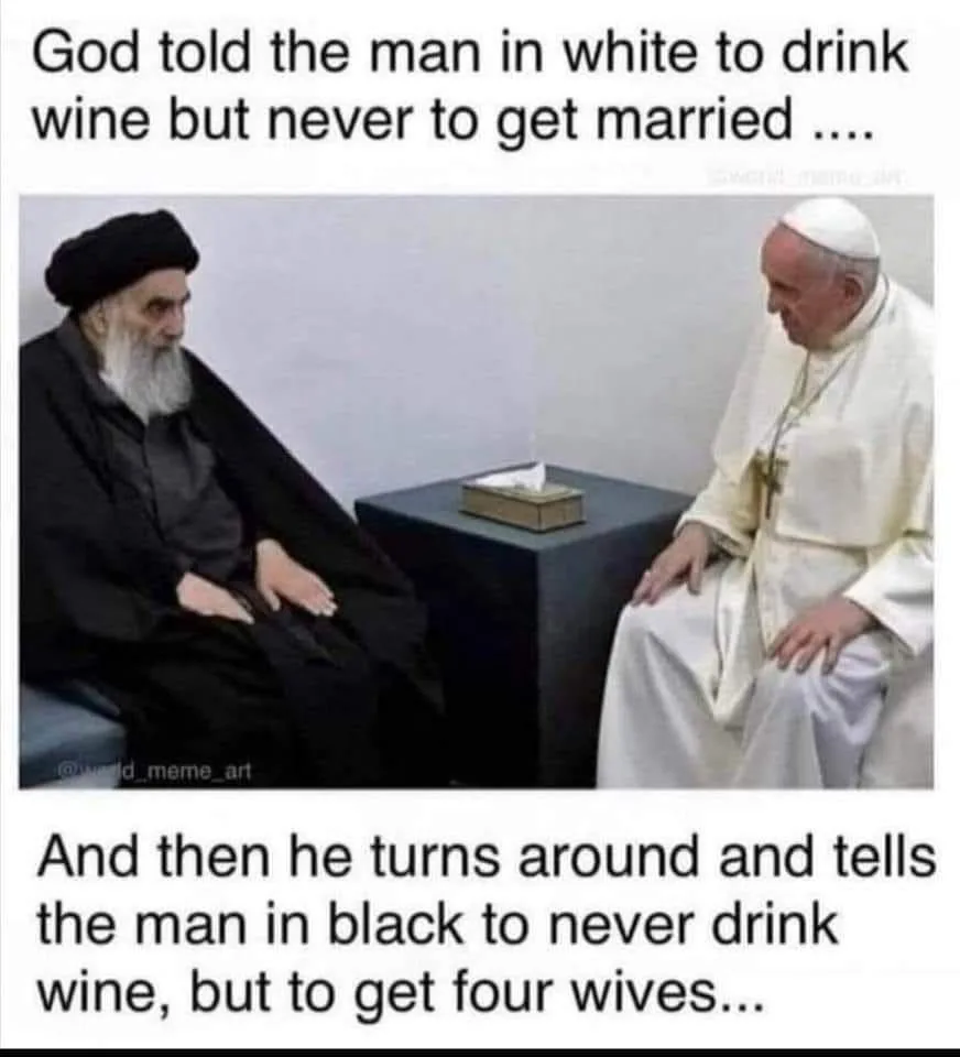 Two men sit facing each other across a small table with a tissue box on it. The man on the left wears a black robe and…