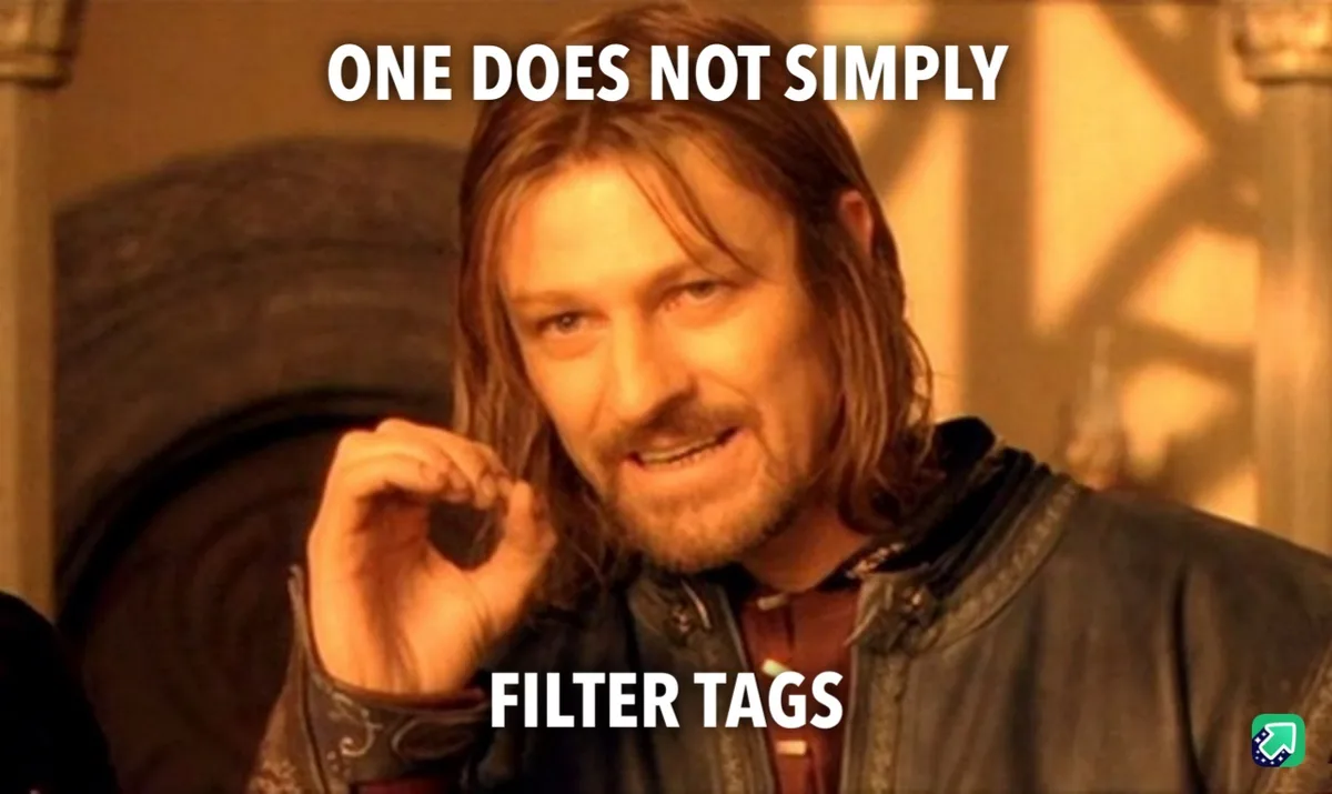 A man with long hair and a beard, wearing a dark leather jacket, holds a small object in his hand while looking at the…
