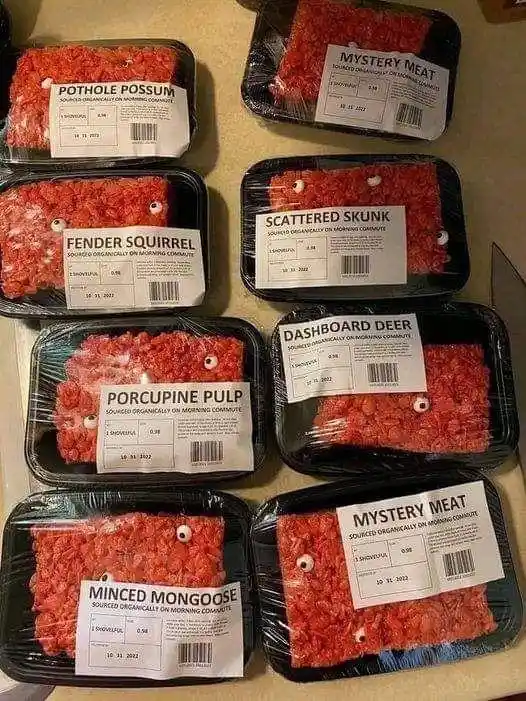 An image displays eight black plastic containers filled with red, textured food resembling ground meat, each with a white…