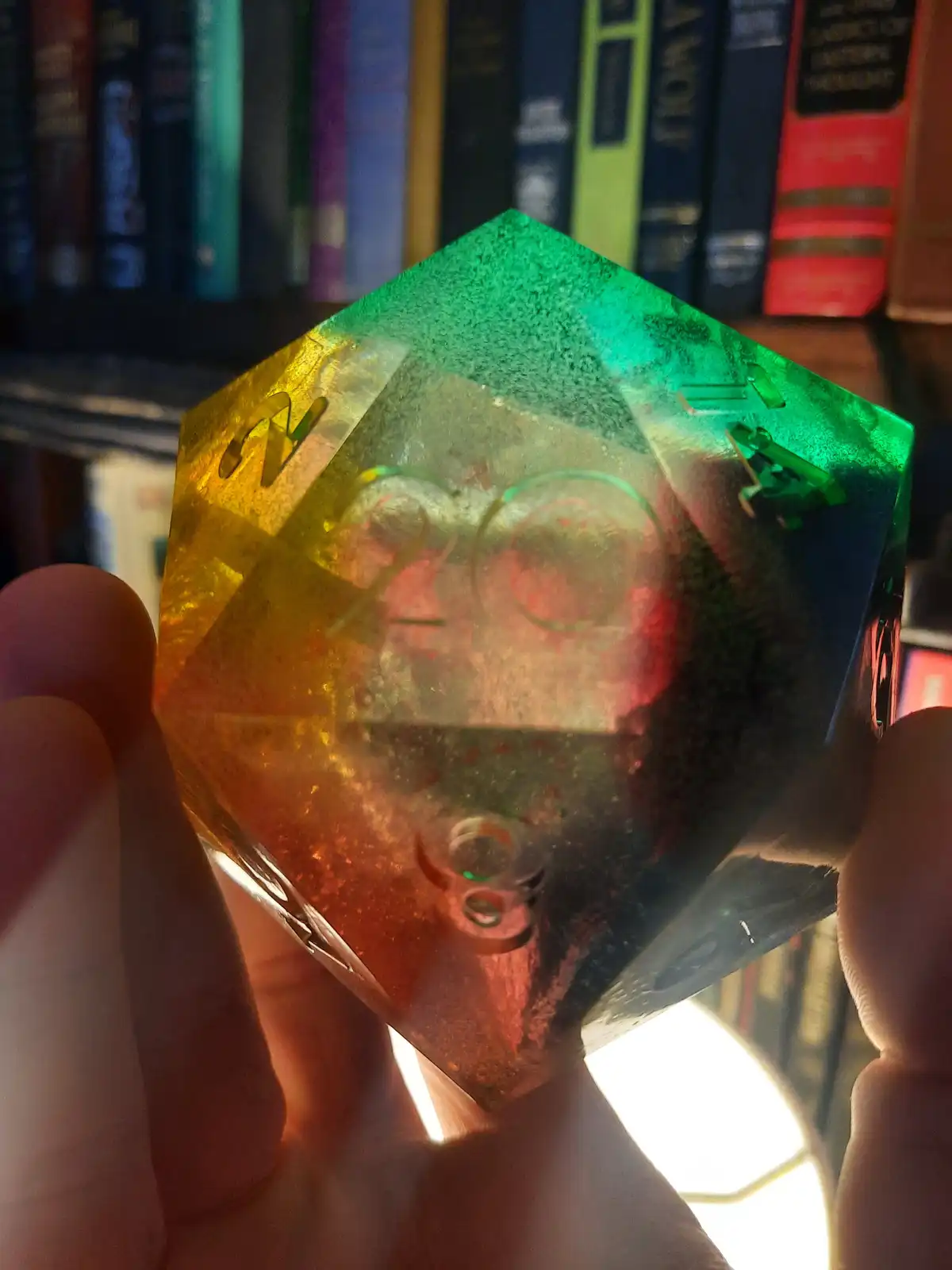 A hand holds a translucent, glitter-filled 20-sided die (d20) with the number 20 prominently visible on its face, set…