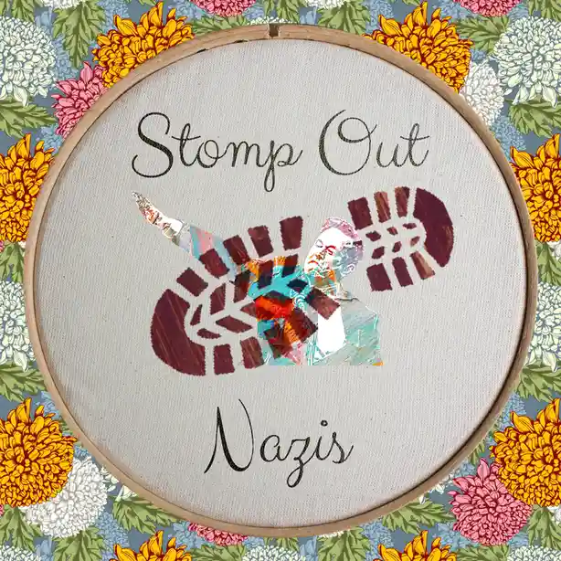An embroidery hoop with a floral pattern background contains a stitched design of a person stomping on a swastika, with the…