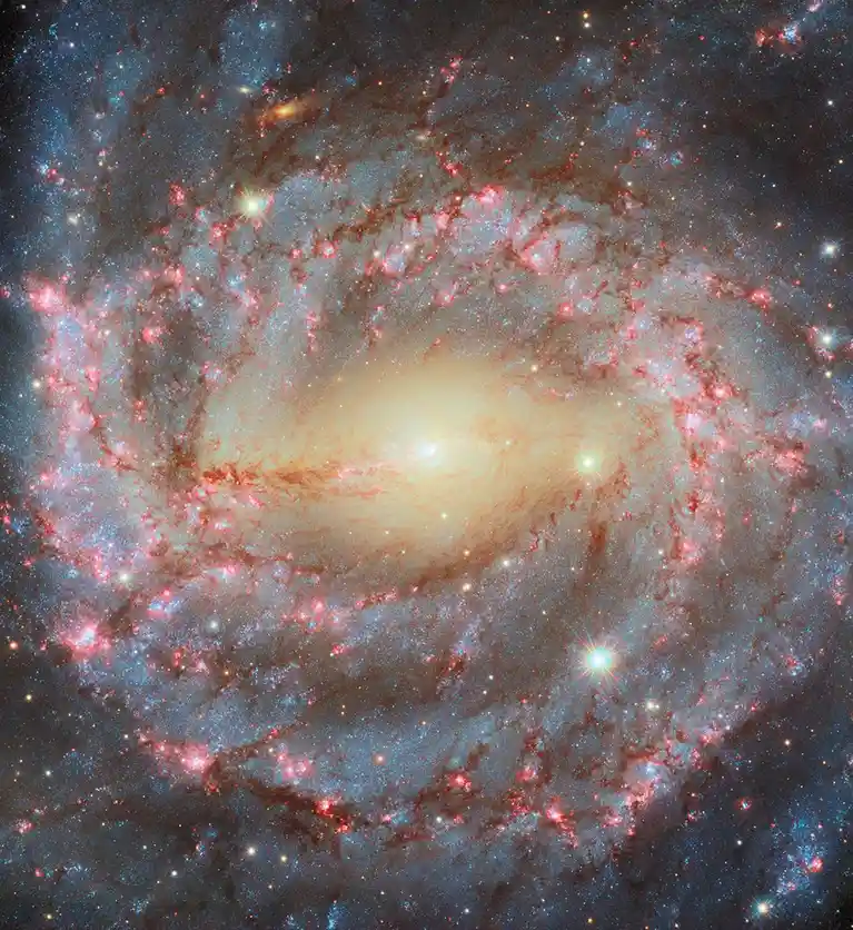 A vibrant spiral galaxy image with swirling arms of red and blue star clusters and bright stars, overlaid with the text 'i'm…