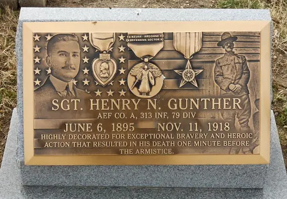 A gravestone for Sgt. Henry N. Gunther, decorated with military medals and portraits, includes text stating he died one…