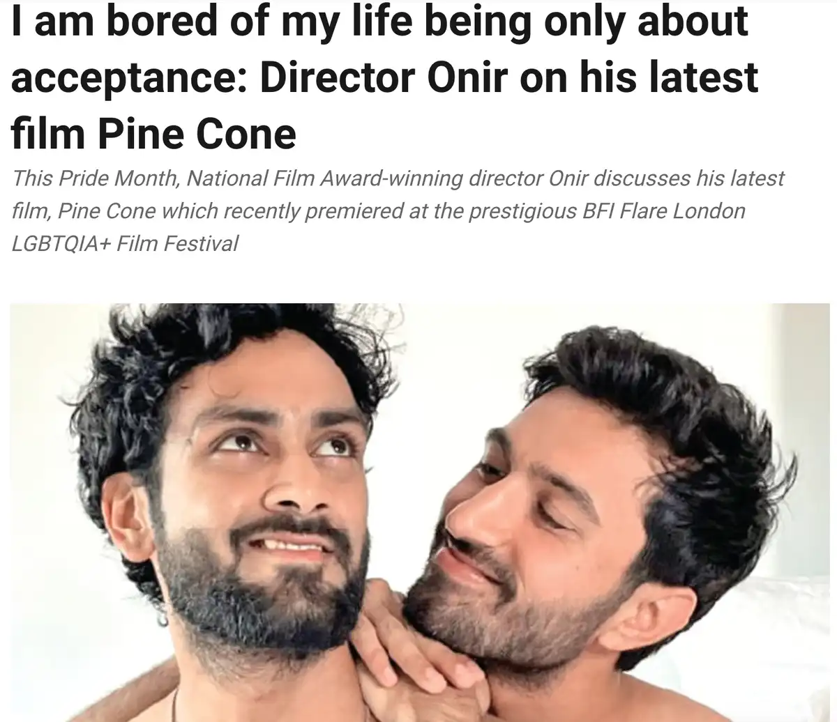 The image shows two men in a close, affectionate pose, one with his hand on the other's neck. The overlaid text reads 'I am…