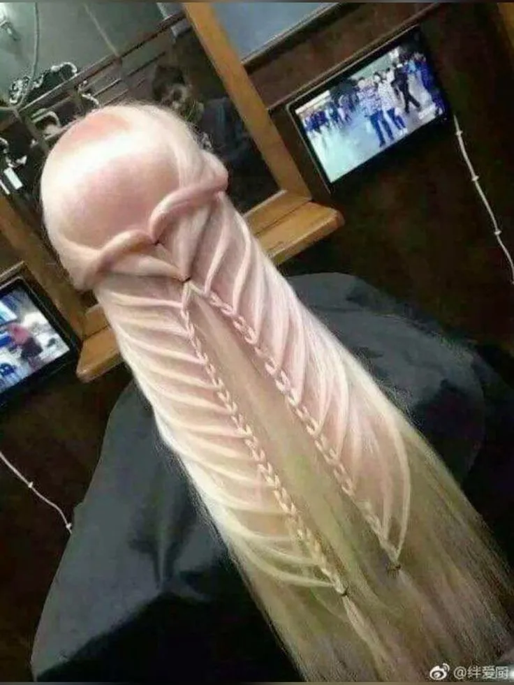 a person with very long, light-colored hair is shown from behind, seated in a salon chair, wearing a black cape. Their hair…