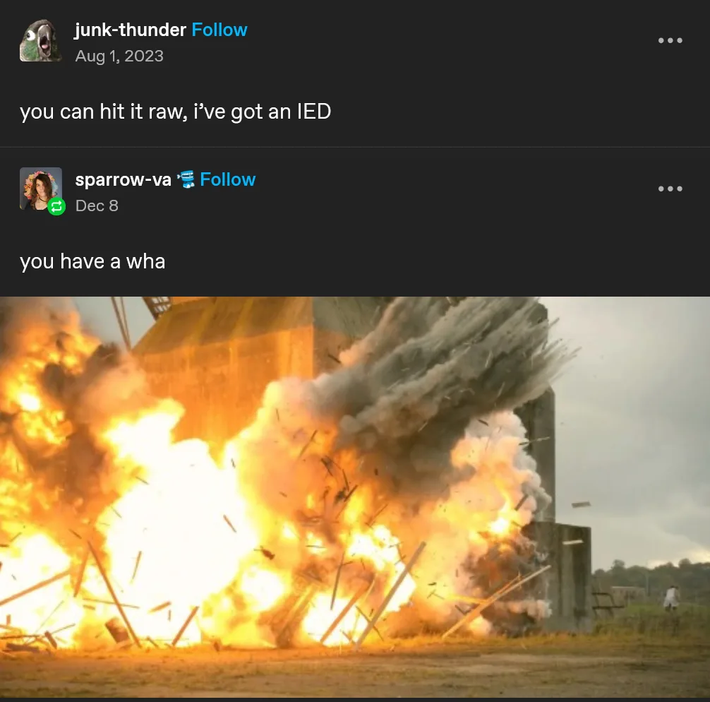 The image shows a large, fiery explosion tearing through a concrete structure, sending debris flying and billowing thick…
