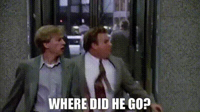 A four-panel meme featuring two men in suits reacting with increasing shock and confusion as they look around, each panel…