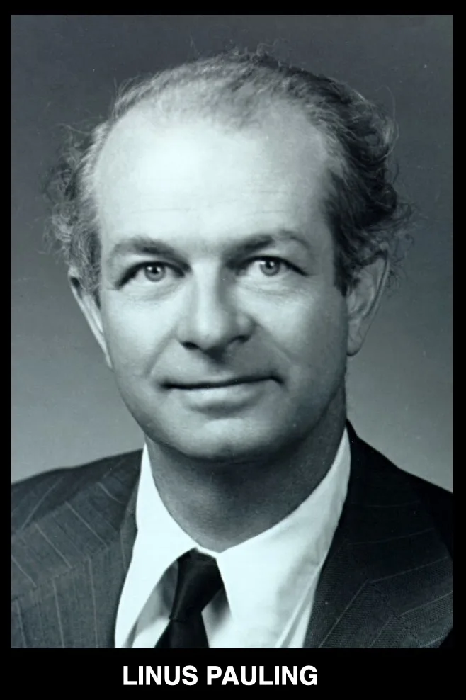 A black-and-white portrait of a middle-aged man with receding hairline and a slight smile, wearing a pinstripe suit and tie…