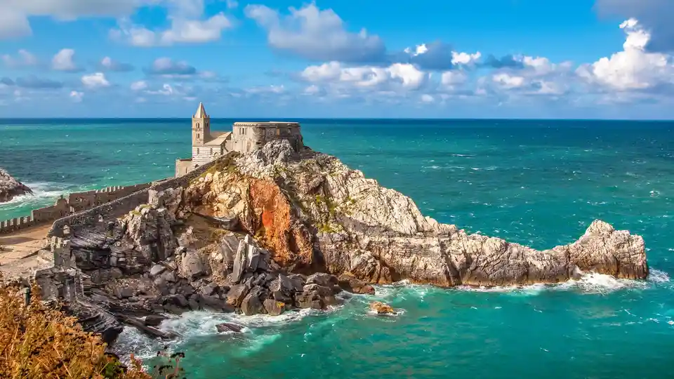 A triangular peninsula's tip invites exploration, pointing to the Ligurian Sea. The Church of St. Peter crowns the cape…