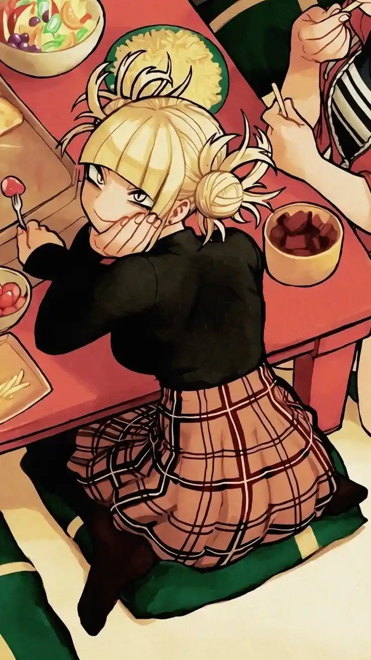 A blonde anime girl with her hair in a messy bun sits at a red table, covering her mouth with her hand while holding a fork…