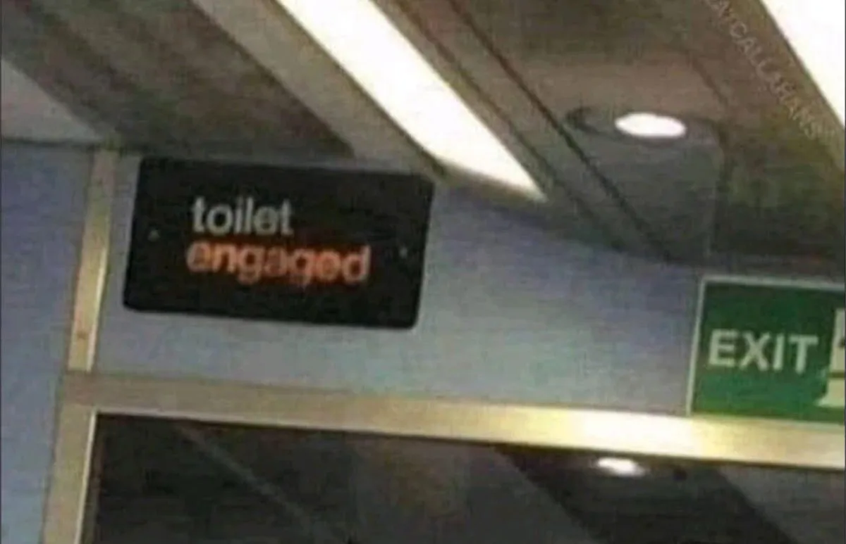 A low-resolution image shows a digital sign inside a public transport vehicle, likely a train or bus, displaying the text…