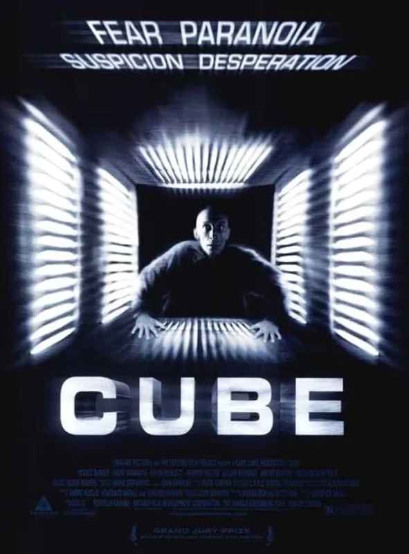 A movie poster for the film 'Cube' shows a man in a dark, confined space with bright, glowing, slatted walls surrounding…