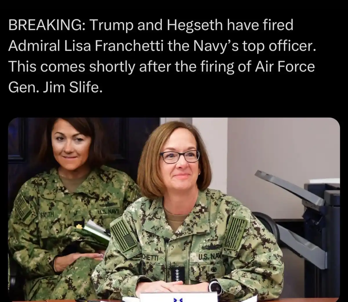 Two women in U.S. Navy camouflage uniforms sit at a table; the woman in front, with glasses and name tag 'CHETTI', has a…