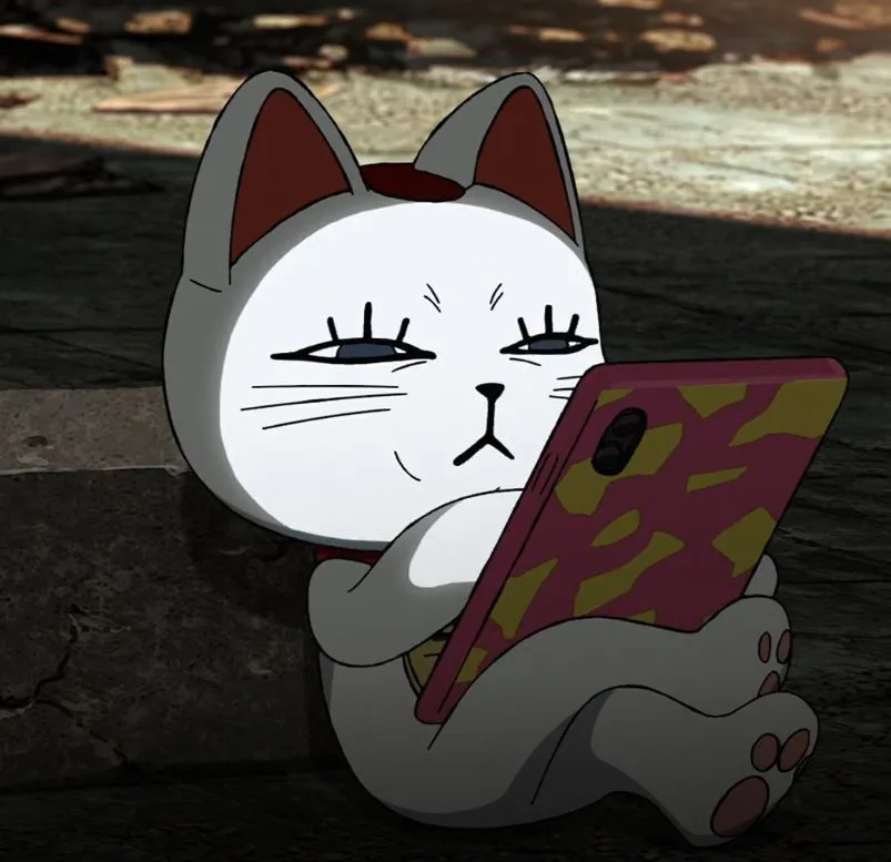 A white cartoon cat with grey ears and paws sits cross-legged on a stone surface, holding a smartphone with a pink and…