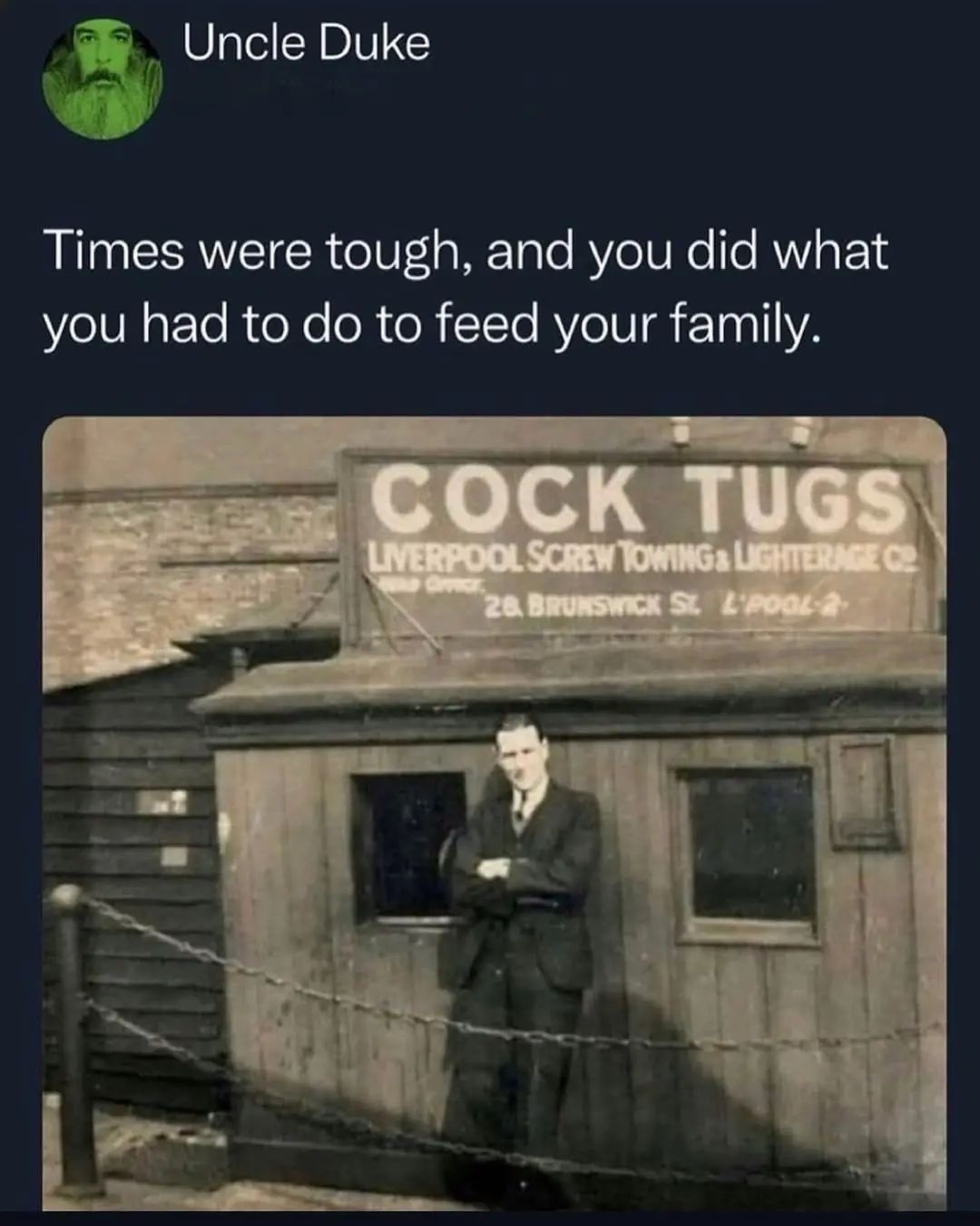 A sepia-toned historical photo shows a man in a suit standing confidently with arms crossed in front of a wooden building…