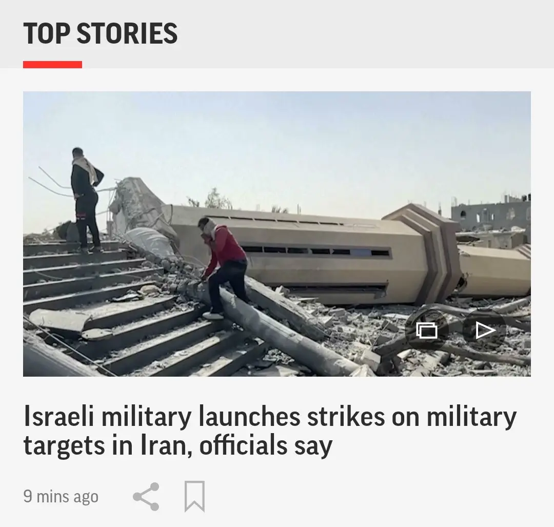 The image shows a news feed interface with a 'TOP STORIES' header. Below it, a photo depicts two men navigating through…