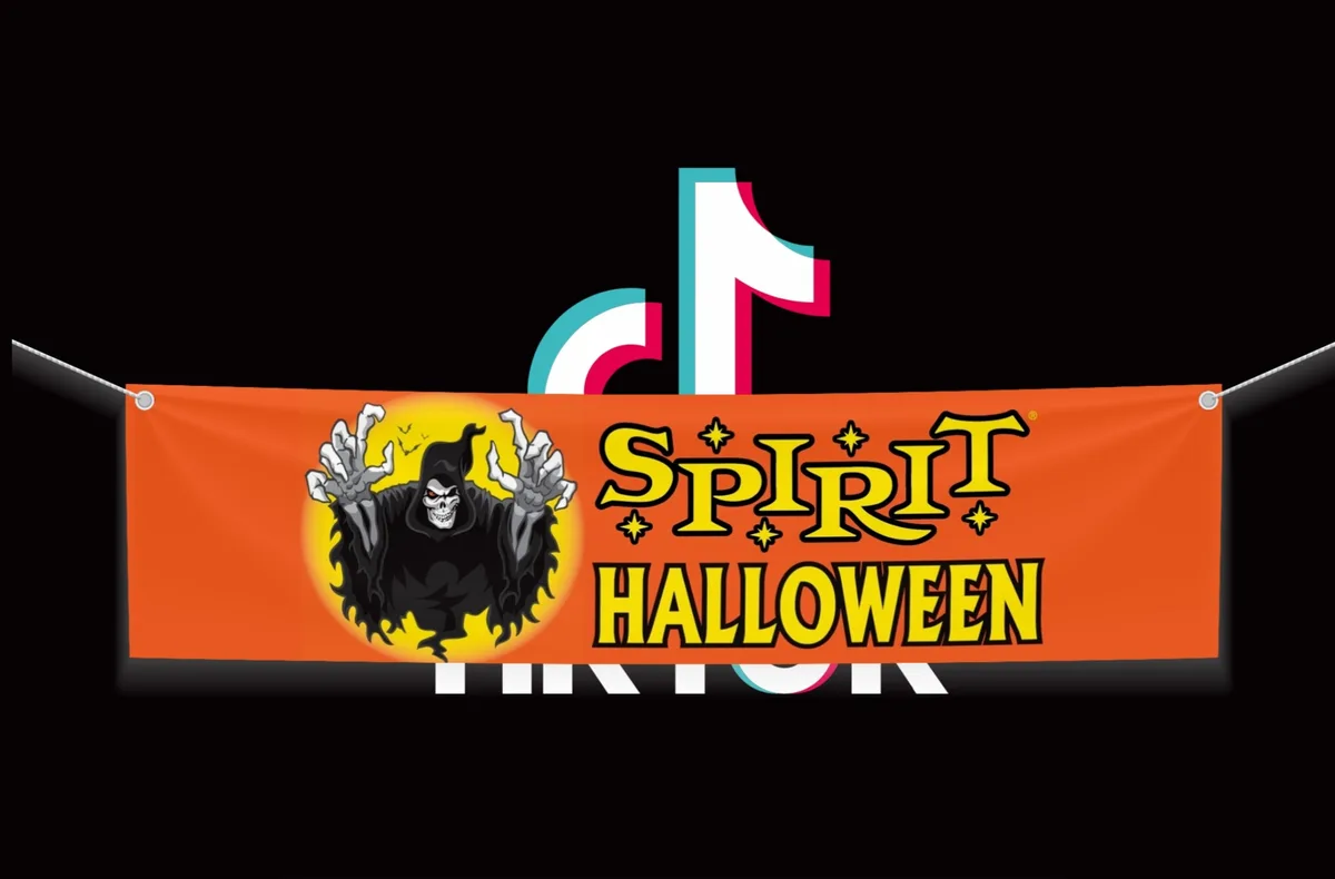An orange Halloween banner featuring a cartoon grim reaper with skeletal hands raised against a yellow sun backdrop, with…