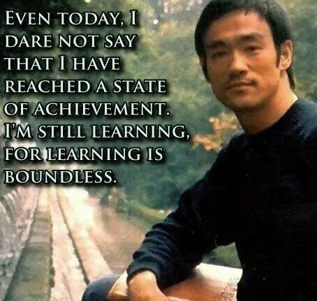 A still image of Bruce Lee sitting outdoors, looking thoughtful, with a quote overlaid in white text that reads: 'EVEN…