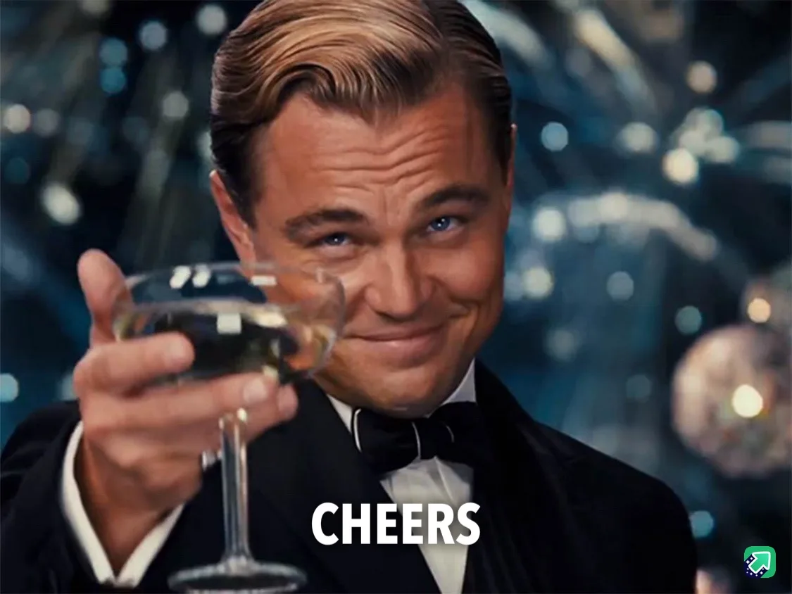 A man in a tuxedo with a bow tie holds up a champagne glass, smiling and looking at the viewer. The word 'CHEERS' is…