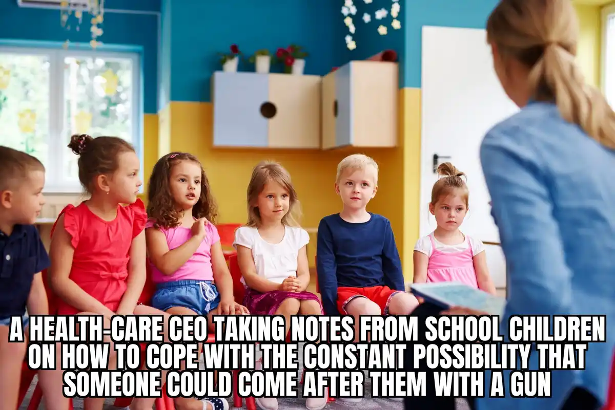 A group of young children sit in a circle in a brightly colored classroom, facing a teacher who is partially visible from…