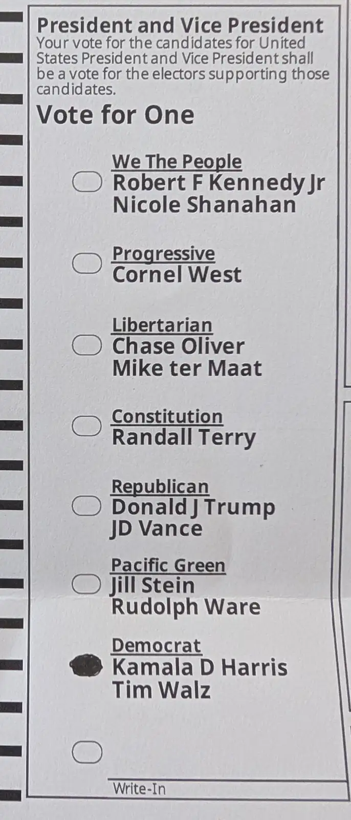 A close-up of a U.S. presidential ballot showing the 'Democrat' ticket for Kamala D Harris and Tim Walz with its oval marked…