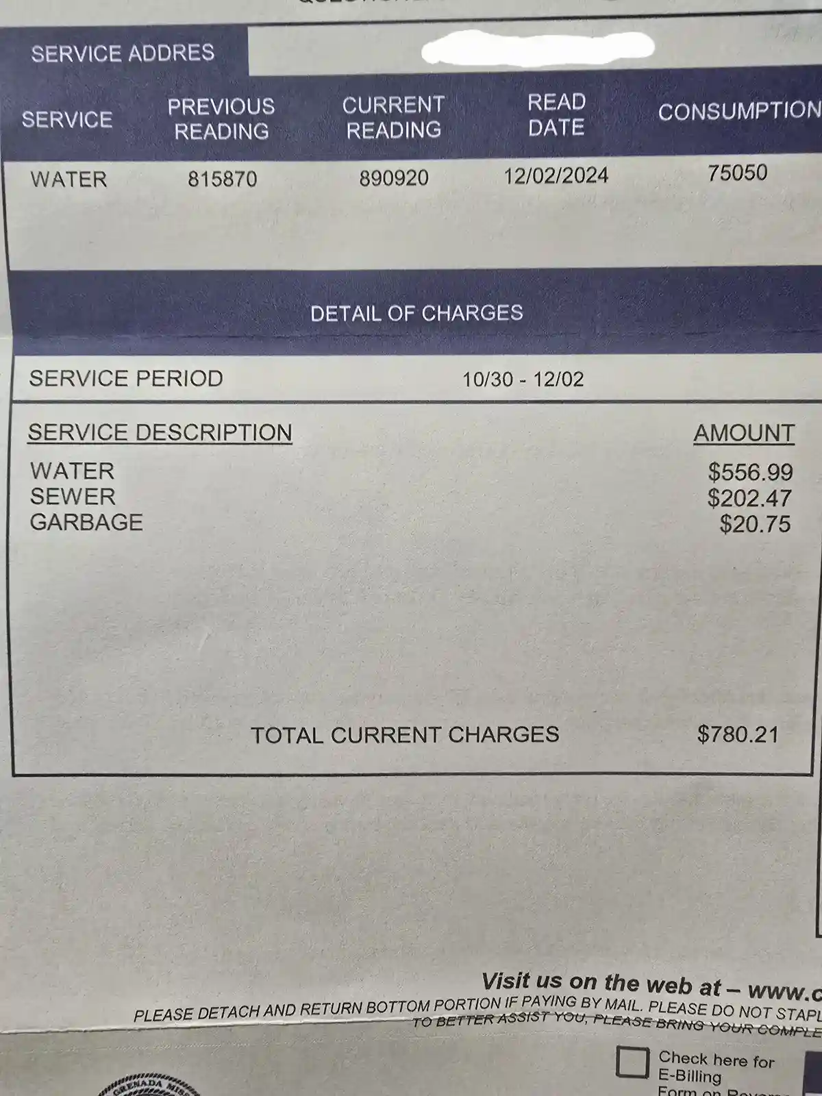 A close-up of a water utility bill showing a high water consumption of 75,050 units over a two-month period, resulting in a…