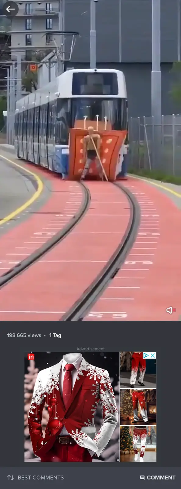 A man is seen standing in front of a tram, holding a broom as if pushing it, while the tram appears to be moving toward him…