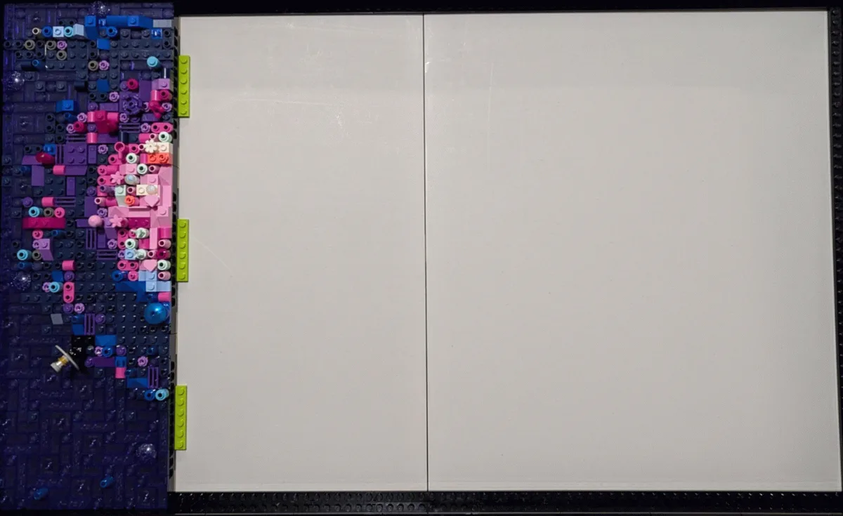 The image shows a large, colorful LEGO galaxy mural being assembled in three stages, with a whiteboard panel inserted in the…