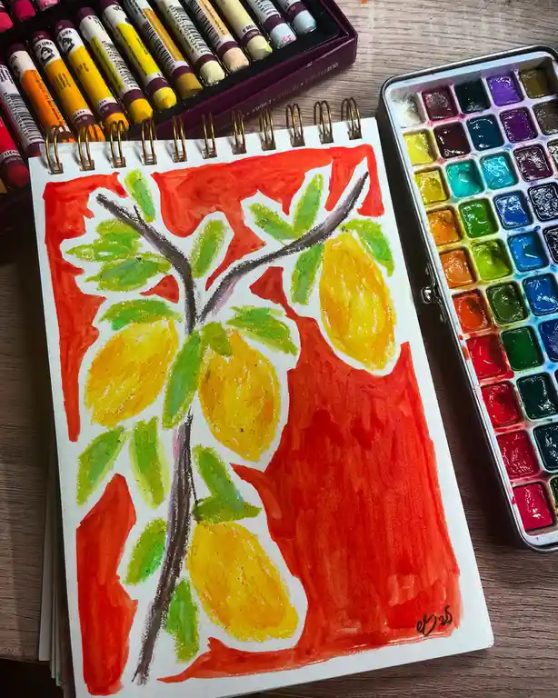 A colorful drawing in a spiral-bound sketchbook shows a stylized tree with green leaves and a brown trunk, set against a…