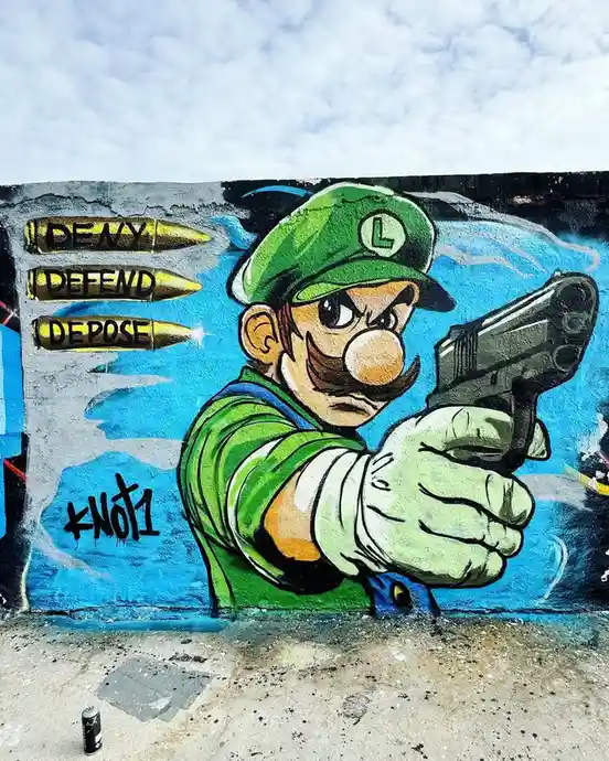 A graffiti mural depicts the video game character Luigi holding a handgun, with three golden bullets floating beside him…