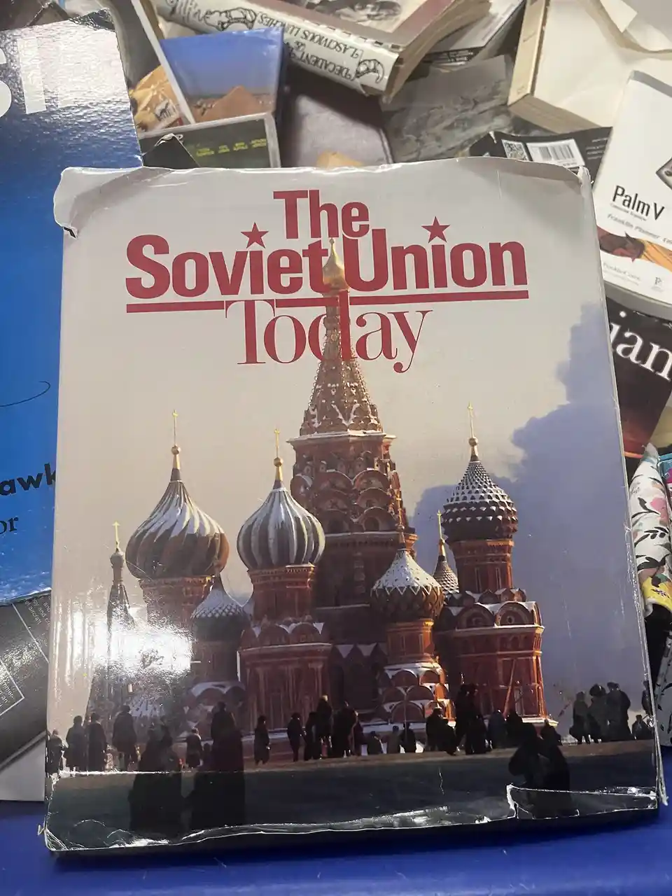 A book titled 'The Soviet Union Today' with a cover photo of St. Basil's Cathedral in Moscow, surrounded by snow and people…