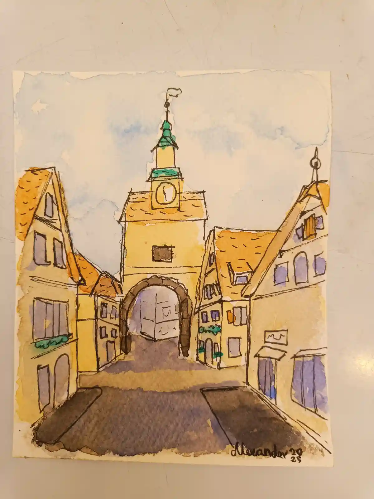A watercolor painting of a European-style town square with a central clock tower and arched gateway, flanked by buildings…