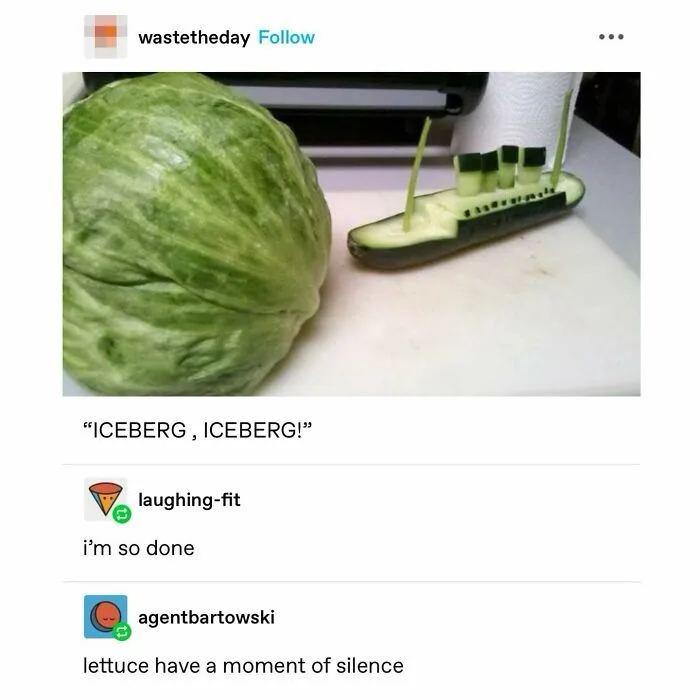 A large green cabbage sits next to a cucumber carved to look like the Titanic, complete with smokestacks and a hull. The…