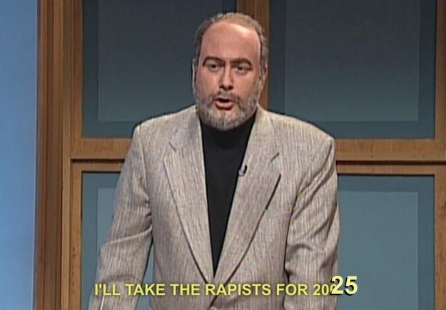 A man with a beard and gray suit stands in front of a wooden-framed blue background. Yellow text at the bottom reads 'I'LL…