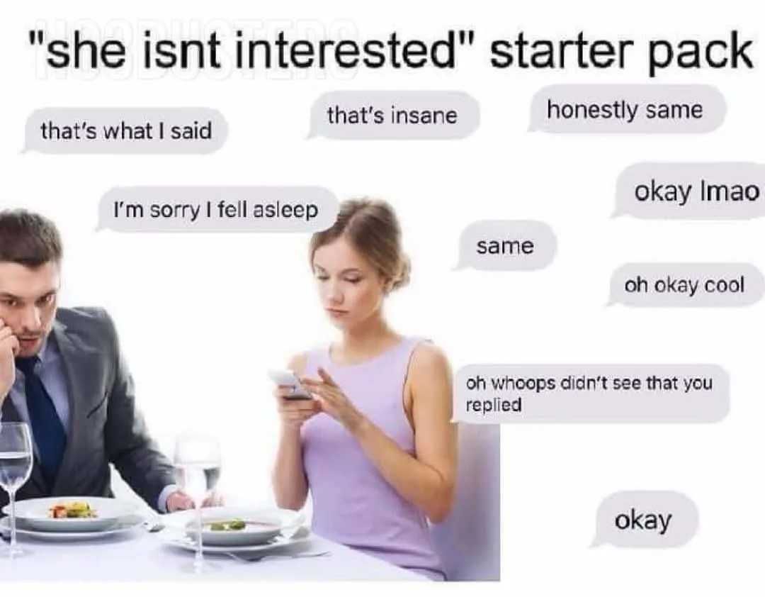 A man and woman sit at a dinner table; the woman looks at her phone while the man stares at her with a confused expression…