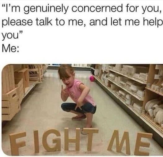A young girl crouches in a store aisle, making a defiant face and pointing at large wooden letters spelling 'FIGHT ME' on…