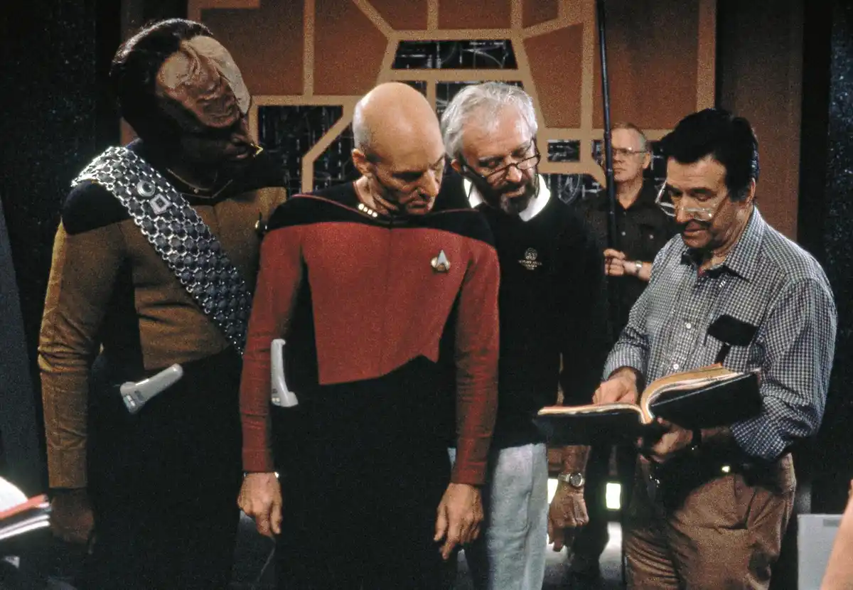 A behind-the-scenes photo from Star Trek: The Next Generation shows actor Patrick Stewart as Captain Picard, a Klingon…